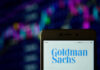 Phone displaying Goldman Sachs logo in front of chart