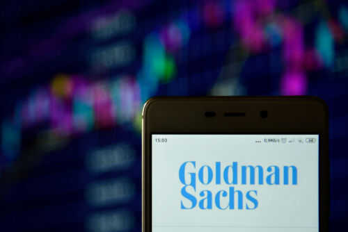 Phone displaying Goldman Sachs logo in front of chart
