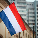 Netherlands flag waving outside buildings