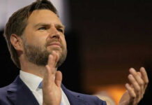 Person clapping enthusiastically in formal attire