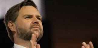 Person clapping enthusiastically in formal attire