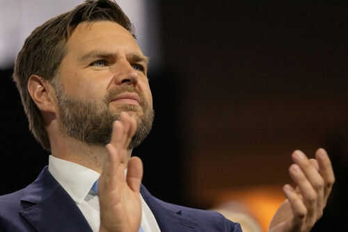 Person clapping enthusiastically in formal attire