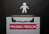 Clipboard with missing person sign and silhouette figure