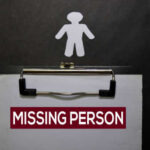 Clipboard with missing person sign and silhouette figure