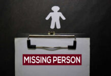 Clipboard with missing person sign and silhouette figure