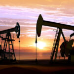 Oil pumps silhouetted against a sunset sky