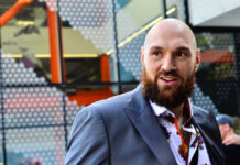 Man with a beard wearing a colorful shirt and a suit in an urban environment