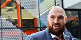 Man with a beard wearing a colorful shirt and a suit in an urban environment