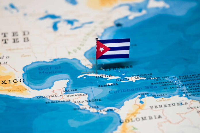shutterstock_1326836042 (1).jpg A small Cuban flag placed on a map highlighting Cuba in the Caribbean