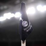 Tottenham Hotspur corner flag illuminated by stadium lights