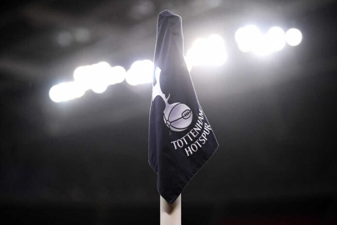 Tottenham Hotspur corner flag illuminated by stadium lights