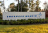 Sign displaying the Lockheed Martin logo in a landscaped area