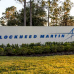 Sign displaying the Lockheed Martin logo in a landscaped area
