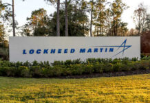 Sign displaying the Lockheed Martin logo in a landscaped area