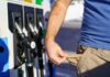 Person showing empty pockets at a gas station