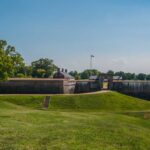 D.C. Park SHOCKER: Bomb Threat Unfolds Historic fort with grassy landscape and trees under a clear blue sky