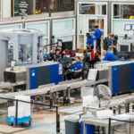 Airport security checkpoint with travelers and TSA agents