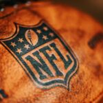 Close-up of an NFL football with the logo and stitching visible
