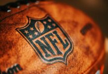 Browns’ 5-Year Trade Push: Will NFL Allow It? Close-up of an NFL football with the logo and stitching visible