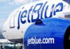 Close-up of a JetBlue airplane showcasing its logo and engine