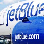 Close-up of a JetBlue airplane showcasing its logo and engine