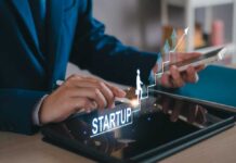 Business professional interacting with a tablet displaying startup growth graphics