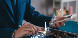 Business professional interacting with a tablet displaying startup growth graphics