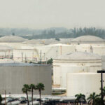 A view of large industrial fuel storage tanks in an urban area