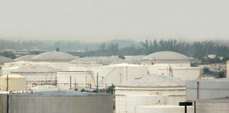 A view of large industrial fuel storage tanks in an urban area