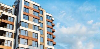 Modern residential building with large windows against a blue sky