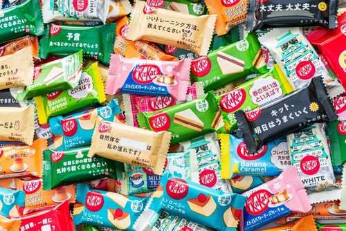 A variety of KitKat chocolate bars in colorful wrappers displayed together