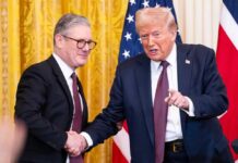 Two political leaders shaking hands during a formal meeting