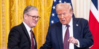 Two political leaders shaking hands during a formal meeting