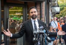 NYC’s Mental Health Plan: Effective or Dangerous? Man in a suit speaking at a press conference with microphones in front of him