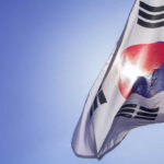 South Korean flag waving against a clear blue sky