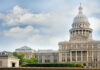 Capitol building with dome and Texas flag displayed