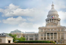 Capitol building with dome and Texas flag displayed