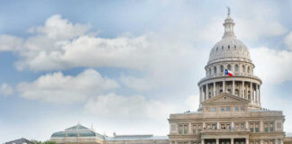 Capitol building with dome and Texas flag displayed