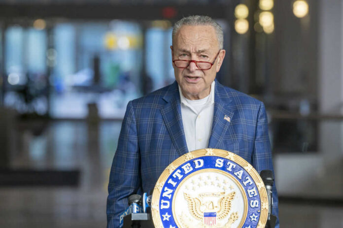 Man speaking at podium with United States emblem.
