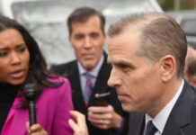 People talking outside with microphones and phone visible