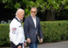 Biden Dynasty Drama: Hunter’s Unchecked Influence Two men walking outside near green bushes