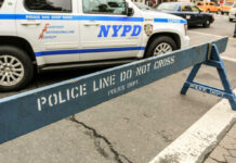 NYPD police barricade on city street with vehicles