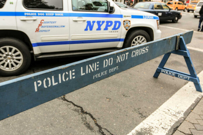 NYPD police barricade on city street with vehicles