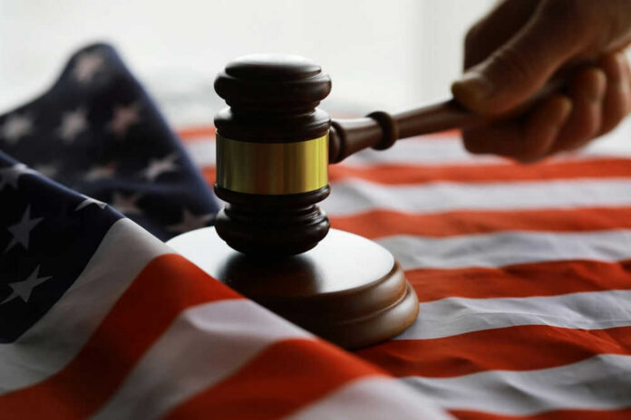 presidentialwire2-1jpg Gavel and hand on American flag.