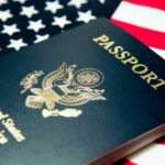 An American passport resting on a background of the U.S. flag