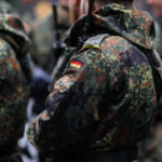 Close-up of soldiers in camouflage uniforms with German flags