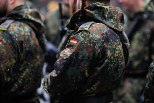 Close-up of soldiers in camouflage uniforms with German flags