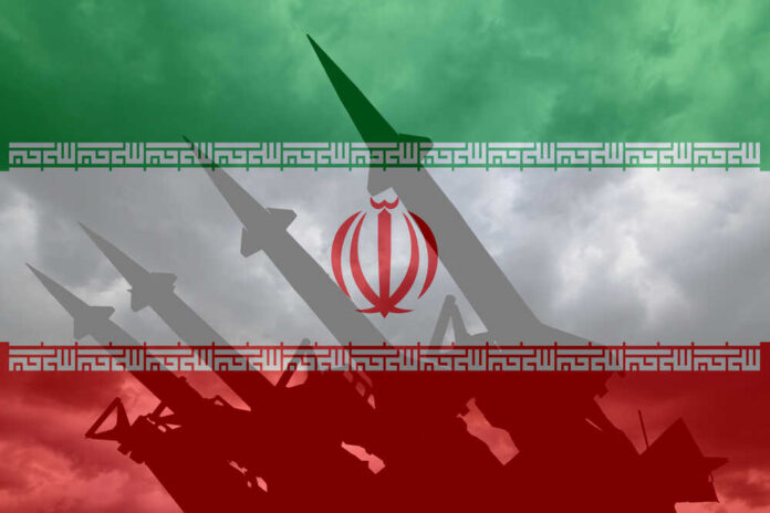 shutterstock_1660469842.jpg Silhouette of missiles against the Iranian flag background
