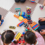 Children playing with colorful educational toys on a mat
