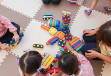 Children playing with colorful educational toys on a mat